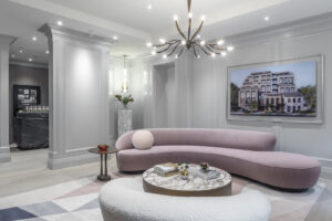 Sophisticated condo lounge with curved pastel seating and contemporary chandelier lighting.