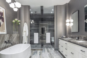 Designer bathroom with dual vanity, soaking tub, and unique geometric lighting at 10 Prince Arthur Condos.