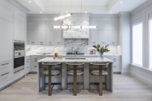 Modern luxury kitchen with marble countertops, high-end appliances, and soft grey cabinetry at 10 Prince Arthur Condos.